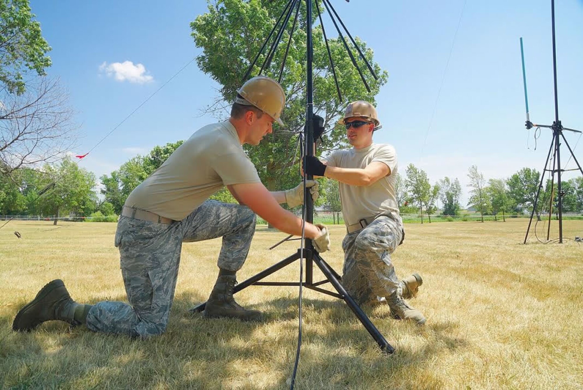 Staff Sgt. Randall J. O’Shea, Cyber Transport Operations Technician, and Airman Justin T. Alt, Radio Transmissions Technician, adjust a Very High Frequency Antenna on July 12, 2016 at the Niagara Falls Air Reserve Station. The antenna is part of a communications package for the Air Force Reserve Command Joint Incident Site Communications Capability UTC deployment taking place on base. (U.S. Air Force photo by Staff Sgt. Richard Mekkri)