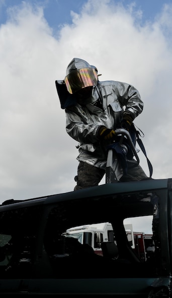 Airman 1st Class Alec Reynolds, 2nd Civil Engineer Squadron firefighter, separates a top hinge from a sliding door during an accident victim extraction exercise at Barksdale Air Force Base, La., July 7, 2016. Airmen practice accessing victims from multiple entrance points maximizing the use of trainer vehicle. (U.S. Air Force photo/Senior Airman Mozer O. Da Cunha)