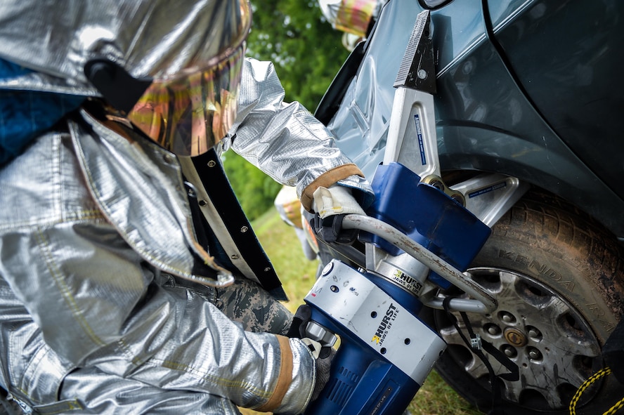 A firefighter from the 2nd Civil Engineers Squadron uses a spreader during an accident victim extraction exercise at Barksdale Air Force Base, La., July 7, 2016. Firefighters took turns using a variety of tools during the exercise to demonstrate the ability to perform with pneumatic and power extraction hand tools during real world emergencies. (U.S. Air Force photo/Senior Airman Mozer O. Da Cunha)