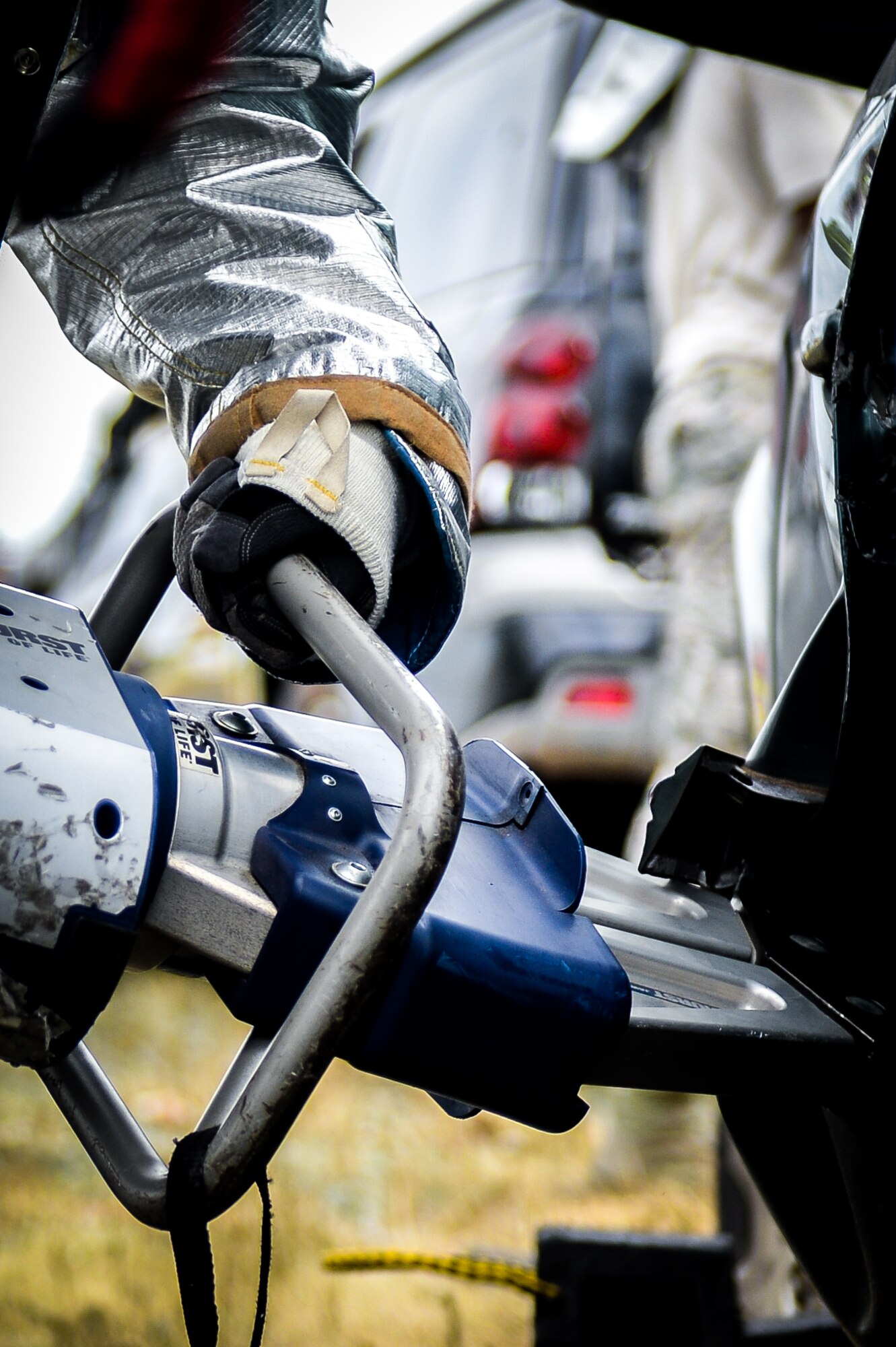 A firefighter from the 2nd Civil Engineers Squadron uses a spreader tool during an accident victim extraction exercise at Barksdale Air Force Base, La., July 7, 2016. The spreader tool was used in multiple roles such as creating hinge access points or generating pressure needed to snap vehicle hinges off, allowing for removal of doors. (U.S. Air Force photo/Senior Airman Mozer O. Da Cunha)