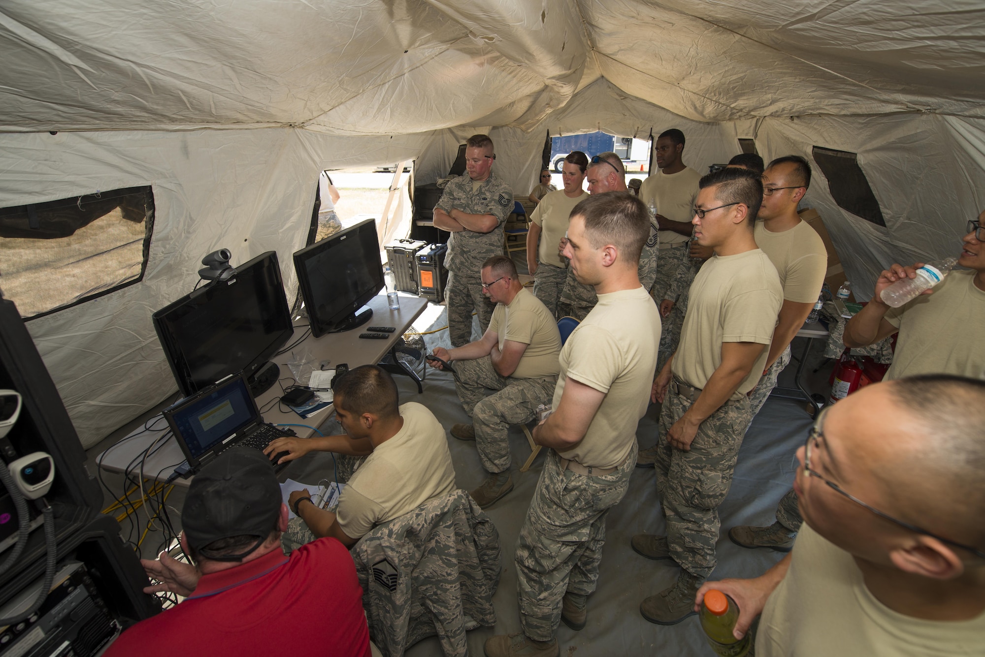 Members of Air Force Reserve squadrons gather as video teleconference equipment is set up during the Air Force Reserve Command Joint Incident Site Communications Capability (JISCC) exercise, July 12, 2016, Niagara Falls Air Reserve Station, N.Y. The exercise is meant to simulate how units would deploy anywhere in the U.S. to enable inter-agency communication during a man-made or natural disaster. (U.S. Air Force photo by Tech. Sgt. Stephanie Sawyer) 


