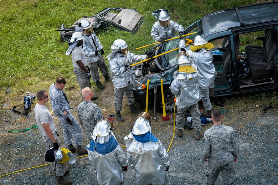 Airmen from the 2nd Civil Engineer Squadron remove a vehicle windshield during an accident victim extraction exercise at Barksdale Air Force Base, La., July 7, 2016. Airmen removed the windshield to gain access to the vehicle roof support posts prior to cutting it from the vehicle. (U.S. Air Force photo/Senior Airman Mozer O. Da Cunha)