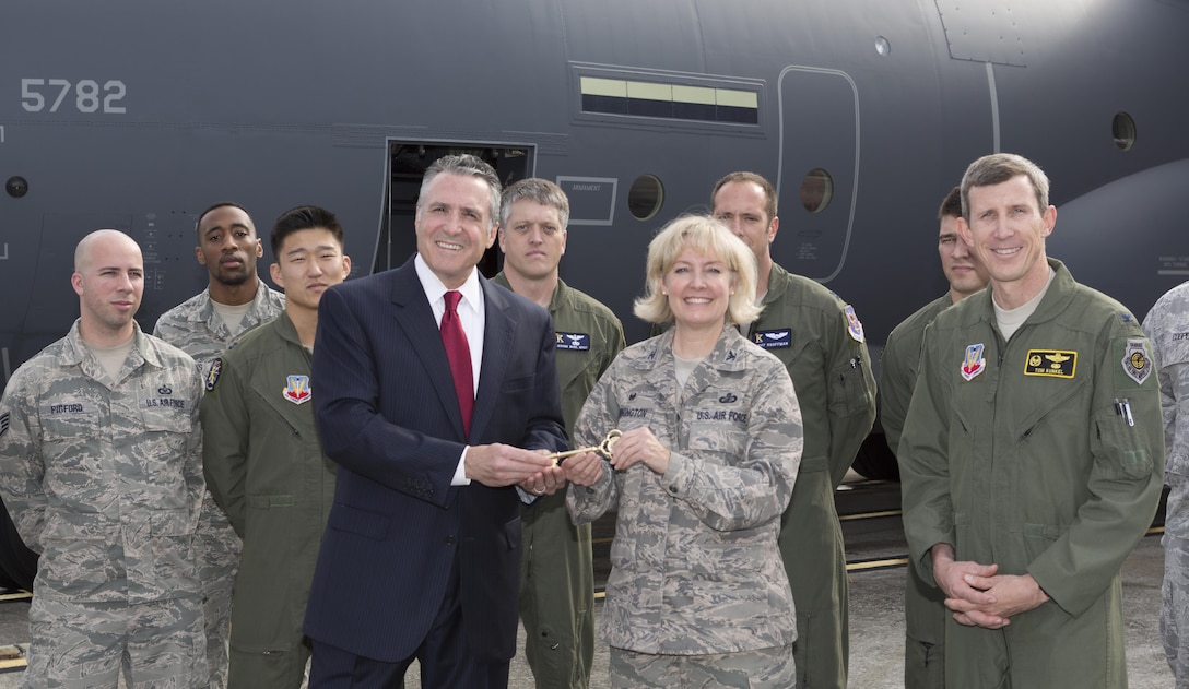 Tony Frese, a Lockheed Martin executive, presents a token of appreciation to Air Force Col. Sheri Bennington, commander of Defense Contract Management Agency Lockheed Martin Marietta, on the milestone of the 2,500th C-130 Hercules rolling off the assembly line. Col. Thomas Kunkel, commander of the 23rd Wing at Moody Air Force Base, Georgia, and crew from the wing were involved in the transfer of the aircraft from Marietta, Georgia, to the base.