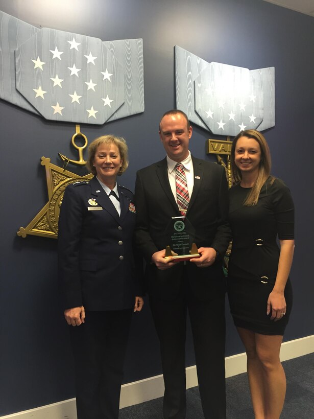 Air Force Lt. Gen. Wendy Masiello, Defense Contract Management Agency director, and Jennifer Connell, wife of DCMA employee Ryan Connell, congratulate him on receiving a 2015 Defense Acquisition Workforce Individual Achievement and Development Award Dec. 10. 