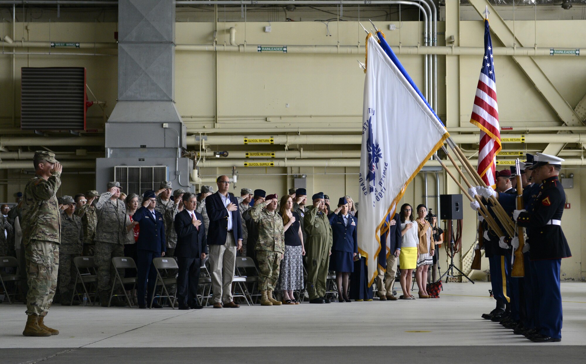 Army Col. Timothy Wulff salutes the flag during the playing of the National Anthem at the 673d Air Base Wing and Joint Base Elmendorf-Richardson, Alaska change of command ceremony at Hangar 1, July 11, 2016. U.S. Air Force Col. Brian Bruckbauer turned over command to Air Force Col. George Dietrich III as Air Force Lt. Gen. Russell Handy, the appointed commander of Pacific Air Forces; Air Component Commander for the U.S. Pacific Command, officiated before gathered family members, distinguished guests and military personnel. (U.S. Air Force photo by Senior Airman Kyle Johnson)