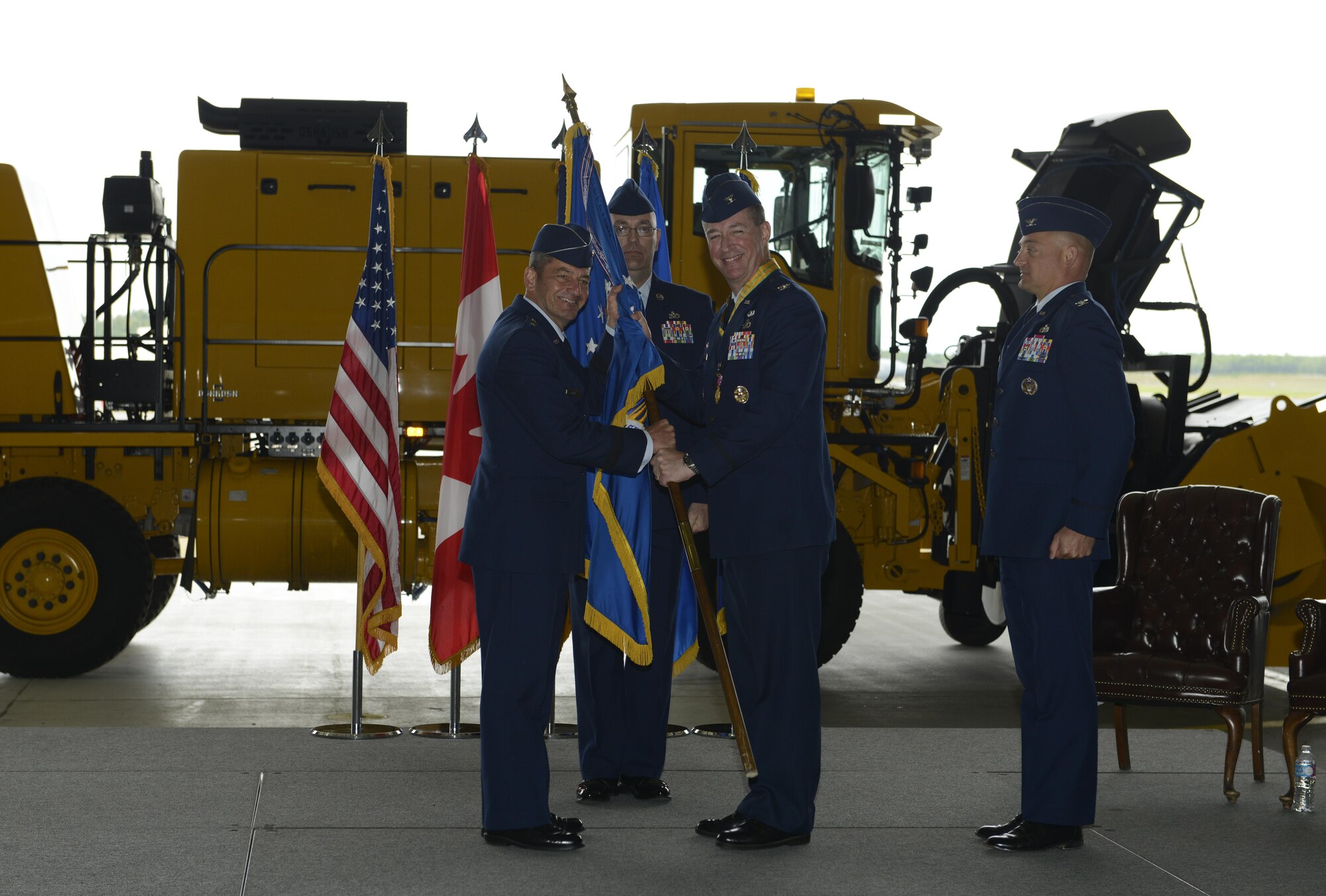 U.S. Air Force Col. Brian Bruckbauer turned over command to Air Force Col. George Dietrich III, July 11 at Hangar 1. Air Force Lt. Gen. Russell Handy, the appointed commander of Pacific Air Forces; Air Component Commander for the U.S. Pacific Command, officiated before gathered family members, distinguished guests and military personnel. (U.S. Air Force photo by Senior Airman Kyle Johnson)