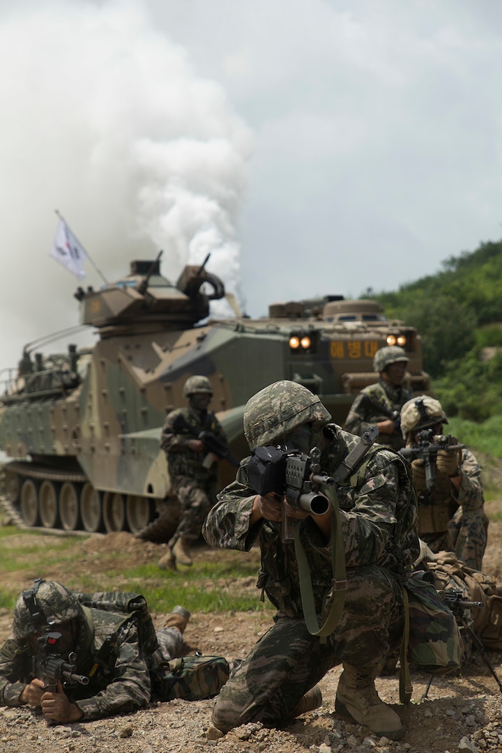 A Republic of Korea, or ROK, Marine sights in alongside U.S. Marines as ROK Assault Amphibious Vehicles shoot off smoke behind them July 6, 2016 at Suseong Range, South Korea during a Korean Marine Exchange Program, or KMEP. The goal of the KMEP is to sustain the combined force and enhance the ROK-U.S. team at the tactical level to build combined warfighting capabilities. During this exercise the Marines carried out a bilateral regimental-sized Marine Air-Ground Task Force operation for the first time. The ROK Marines were a part of 73rd Battalion, 7th Regiment, 1st Marine Division. U.S. service members participating in KMEP 16-11 as part of the ground combat element are with Fox Company, 2nd Battalion, 2nd Marine Regiment, currently assigned to 4th Marine Regiment, 3rd Marine Division, III Marine Expeditionary Force through the unit deployment program. 