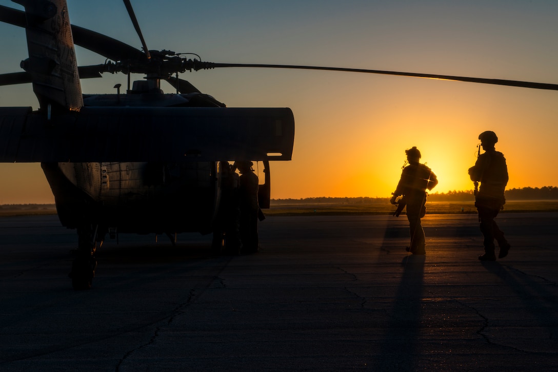 Air Force pararescuemen walk toward an HH-60G Pave Hawk helicopter at Avon Park Air Force Range, Fla., Oct. 9, 2014. Avon Park was named as one of three new participants in the Sentinel Landscapes partnership, in which federal agencies work with state, local and private partners to preserve working and natural lands important to the nation’s defense mission. Air Force photo by Airman 1st Class Ryan Callaghan