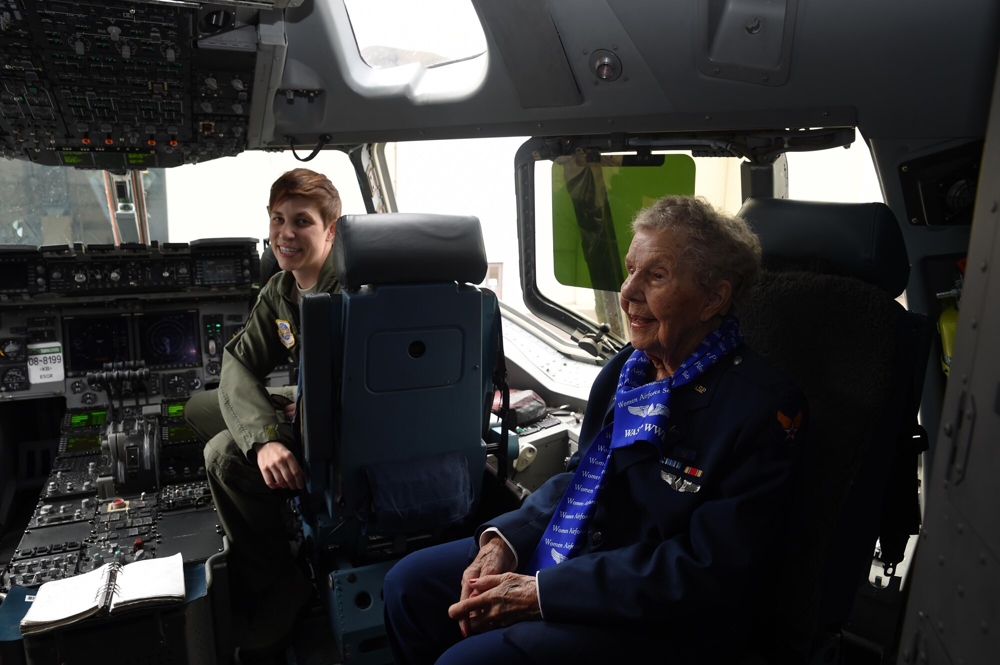 (From left) Maj. Kathryn Benson, McChord C-17 pilot, and Dorothy Olsen, former Women Airforce Service Pilot, sit in the cock-pit of a C-17 Globemaster III on the McChord Field flight line July 10, 2016. Olsen celebrated her 100th birthday at McChord with three fellow WASPs and family. Olsen was also reunited with one of her favorite aircraft’s, the P-51 Mustang. (Air Force Photo/Staff Sgt. Naomi Shipley)
