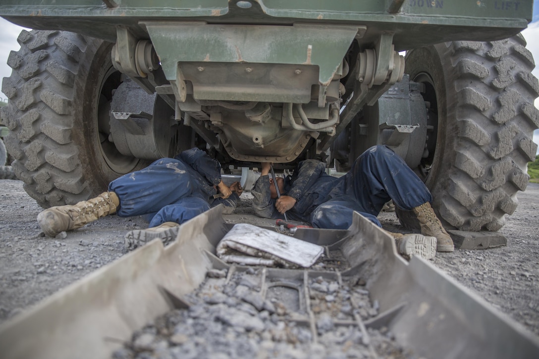 Cpl. Phim P. Yang (left), an automotive maintenance technician with Engineer Support Company, 6th Engineer Support Battalion, 4th Marine Logistics Group, Marine Forces Reserve, and Pfc. Rafael Becerra, an engineer equipment mechanic with Detachment (-), Marine Wing Support Squadron-473, Marine Aircraft Group 41, 4th Marine Aircraft Wing, perform maintenance on a 120M motor grader during Innovative Readiness Training Old Harbor, Alaska, July 10, 2016. IRT Old Harbor is part of a civil and joint military program to improve military readiness while simultaneously providing quality services to underserved communities throughout the United States. (U.S. Marine Corps photo by Sgt. Ian Leones/released)