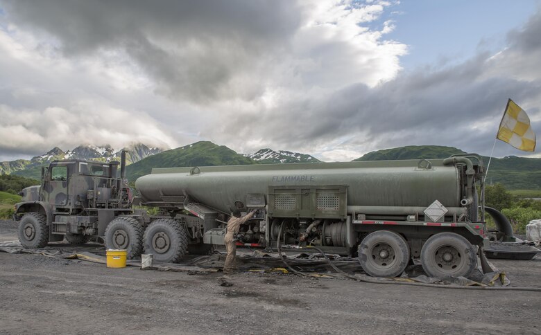 Cpl. Kuwyn Diggs, a semitrailer refueler operator with Detachment (-), Marine Wing Support Squadron-472, Marine Aircraft Group 49, 4th Marine Aircraft Wing, Marine Forces Reserve, performs maintenance on an AMK 970 semitrailer refueler during Innovative Readiness Training Old Harbor, Alaska, July 10, 2016. IRT Old Harbor is part of a civil and joint military program to improve military readiness while simultaneously providing quality services to underserved communities throughout the United States. (U.S. Marine Corps photo by Sgt. Ian Leones/released)