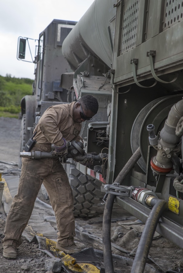 Cpl. Kuwyn Diggs, a semitrailer refueler operator with Detachment (-), Marine Wing Support Squadron-472, Marine Aircraft Group 49, 4th Marine Aircraft Wing, Marine Forces Reserve, defuels the hose on an AMK 970 semitrailer refueler during Innovative Readiness Training Old Harbor, Alaska, July 10, 2016. IRT Old Harbor is part of a civil and joint military program to improve military readiness while simultaneously providing quality services to underserved communities throughout the United States. (U.S. Marine Corps photo by Sgt. Ian Leones/released)