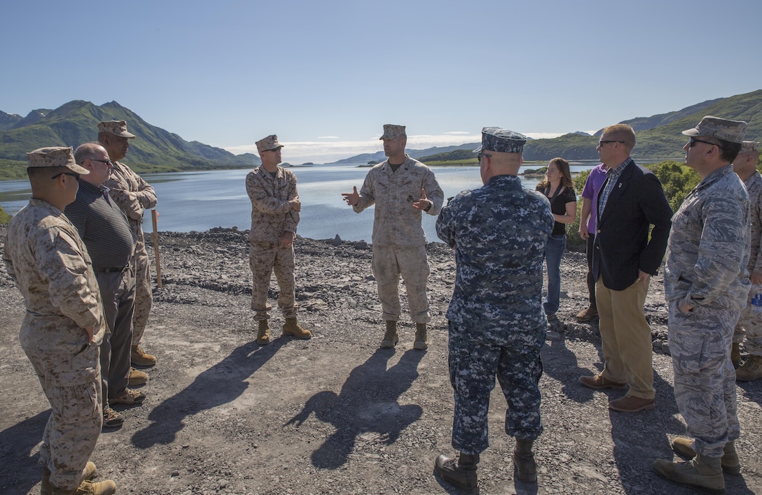 Gunnery Sgt. Brandon Watson (center), project coordinator for Innovative Readiness Training Old Harbor, Alaska, briefs a group of distinguished visitors from different military branches and civilian agencies July 11, 2016. IRT Old Harbor is part of a civil and joint military program to improve military readiness while simultaneously providing quality services to underserved communities throughout the United States. (U.S. Marine Corps photo by Sgt. Ian Leones/released)
