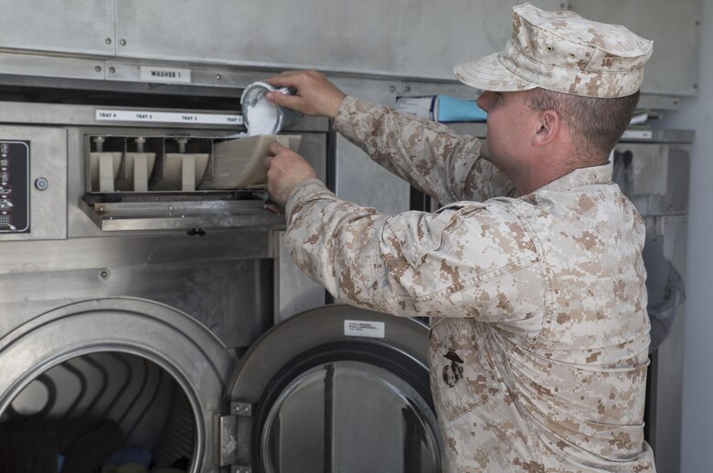 Sgt. Russell J. Slone, a water support technician with Engineer Support Company, 6th Engineer Support Battalion, 4th Marine Logistics Group, Marine Forces Reserve, washes clothing using a containerized laundry unit at Innovative Readiness Training Old Harbor, Alaska, July 11, 2016. The training brought the Marines back to their expeditionary roots and required them to setup electricity, water and other resources to survive in the remote Alaskan environment. IRT Old Harbor is part of a civil and joint military program to improve military readiness while simultaneously providing quality services to underserved communities throughout the United States. (U.S. Marine Corps photo by Sgt. Ian Leones/released)