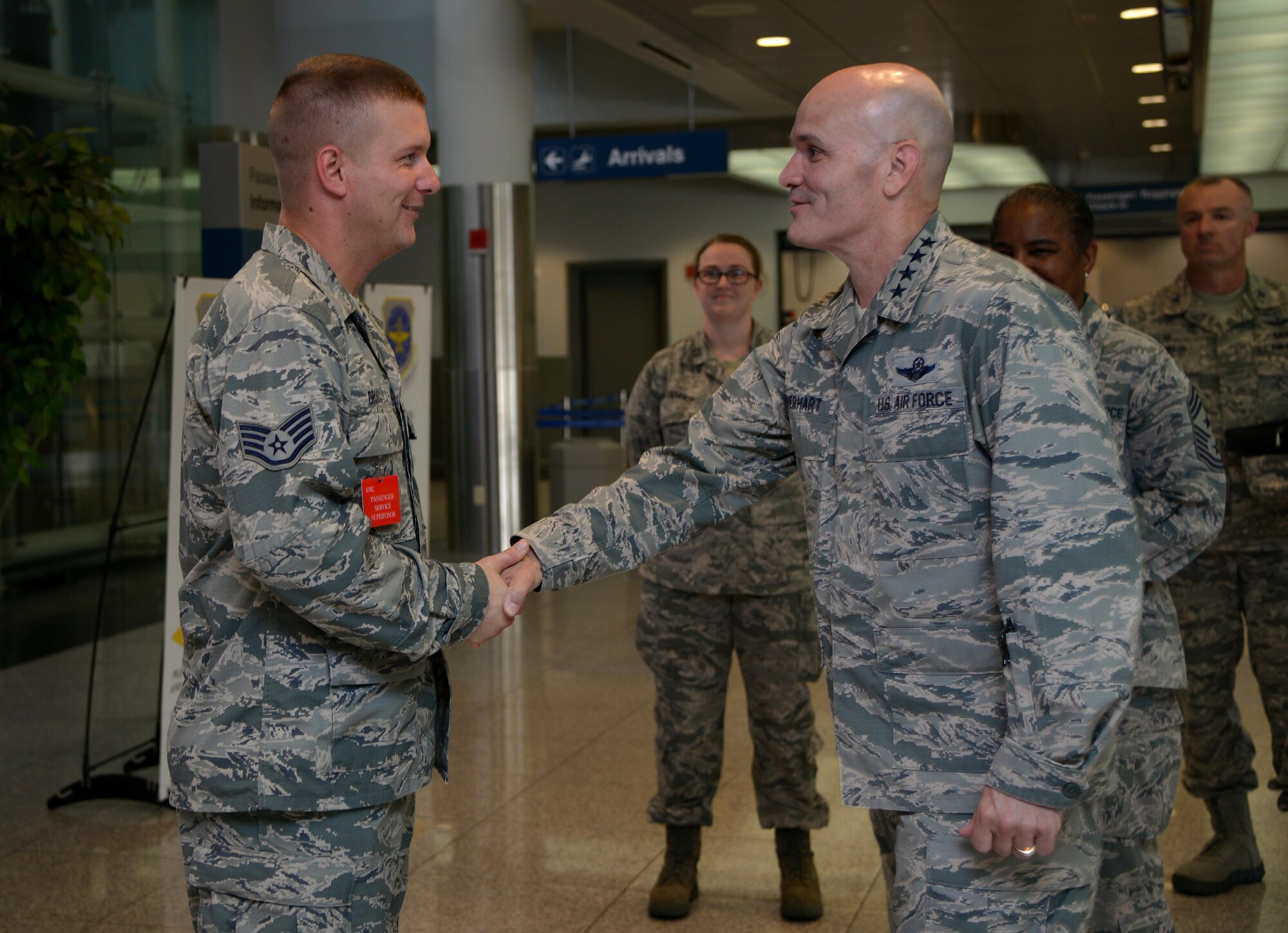 Gen. Carlton D. Everhart II, Air Mobility Command commander, coins Staff Sgt. Frank Brooks, 731st Air Mobility Squadron passenger services supervisor, for being a star performer at the Osan passenger terminal July 11, 2016, at Osan Air Base, Republic of Korea. While visiting Osan AB, the general had lunch with the Airmen from the 731st AMS and toured their facilities to interact with the Airmen and civilians who work to provide precise, reliable airlift worldwide every day. (U.S. Air Force photo byTech. Sgt. Rasheen Douglas/Released)
