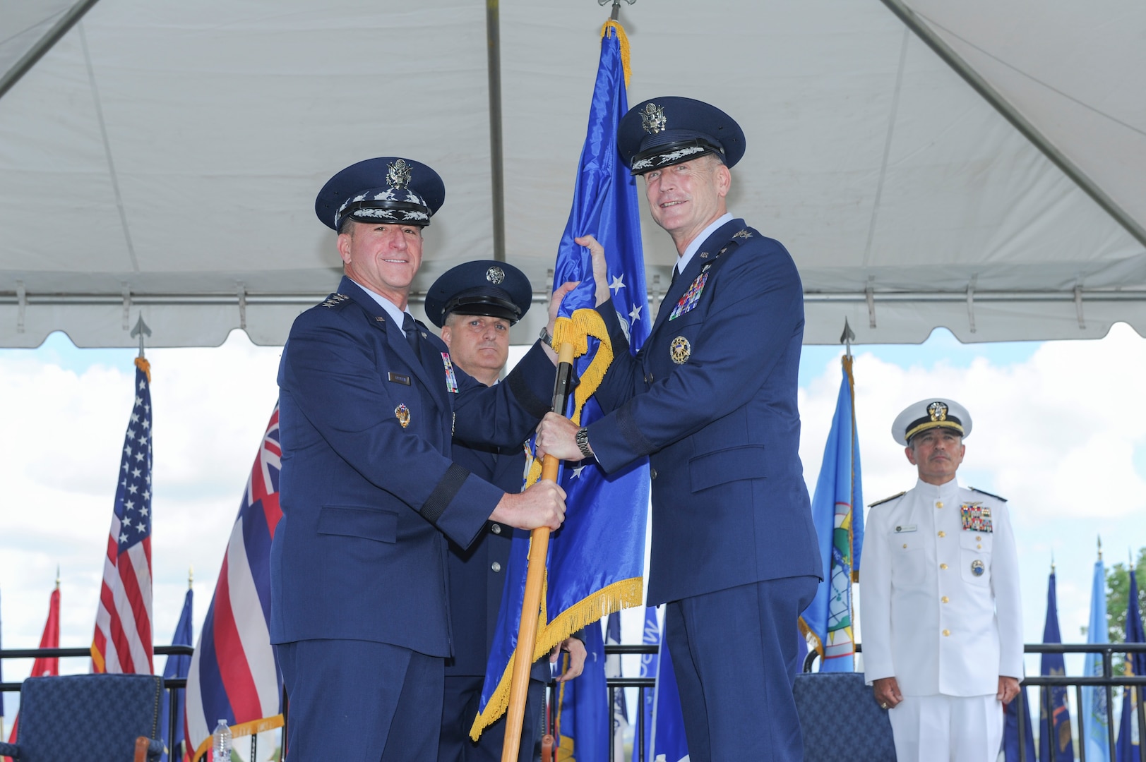 Gen. Terrence J. O’Shaughnessy receives the Pacific Air Forces banner from Gen. David L. Goldfein, U.S. Air Force Chief of Staff, during an assumption-of-command ceremony at Joint Base Pearl Harbor-Hickam, Hawaii, July 12, 2016. O’Shaughnessy was promoted to general prior to the ceremony, attended by Goldfein, and Adm. Harry B. Harris, Jr., U.S. Pacific Command commander. (U.S. Air Force photo by Staff Sgt. Kamaile Chan)