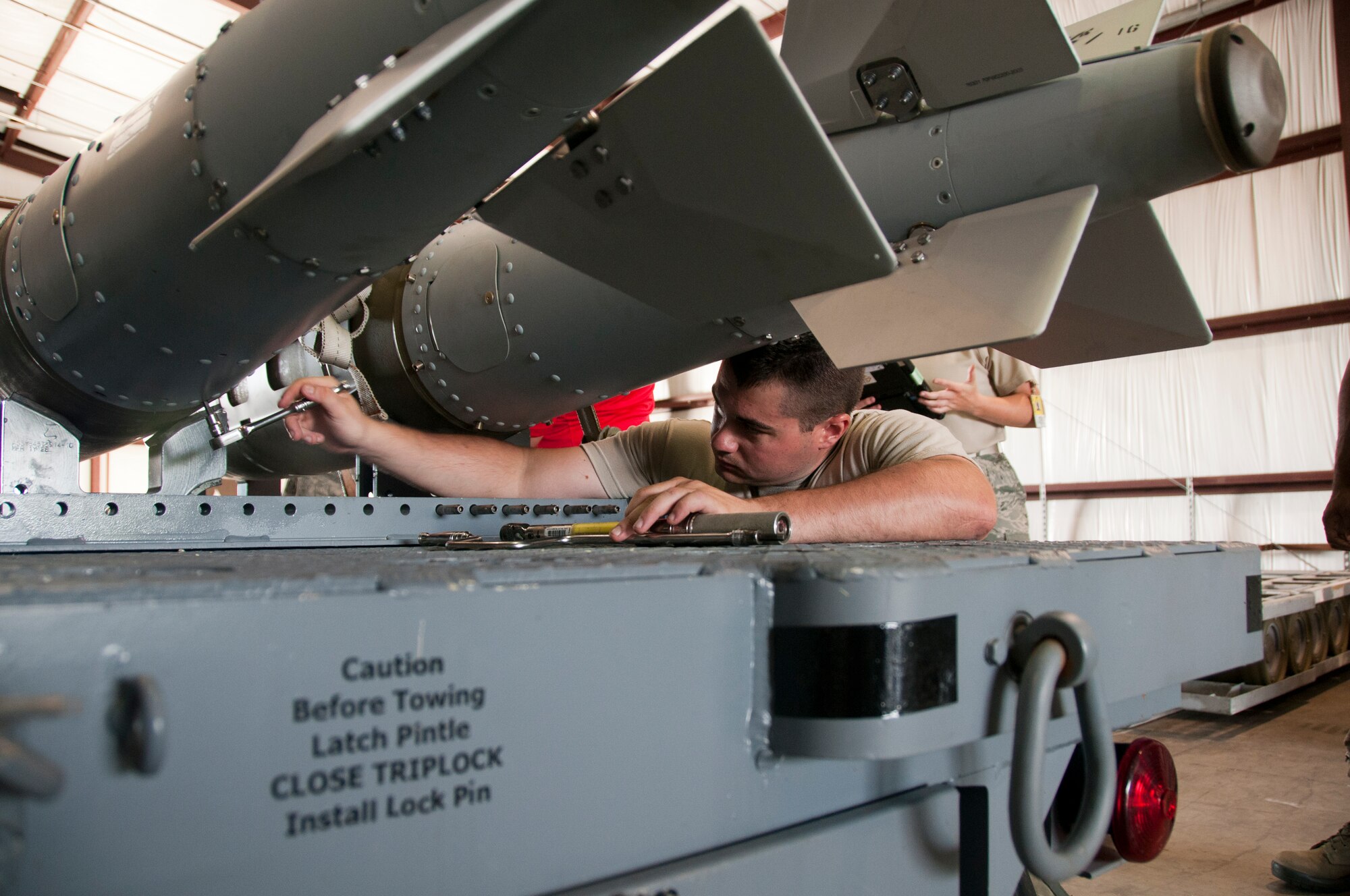 U.S. Air Force Airman 1st Class Randal Trosky, 1st Maintenance Squadron, and Tech. Sgt. Kenneth Stanley, 192nd MXS, ordnance maintenance mechanics, train together while building eight Mark 83 inert bombs for an exercise commemorating Maj. Gen. Billy Mitchell’s bombing of the German battleship Ostfriesland, at Langley Air Force Base, Va., July 10, 2016. Mitchell, often referred to as the ‘Father of the Air Force’, sunk the ship to prove a case for the power of an independent air service.  (U.S. Air National Guard photo by Master Sgt. Carlos J. Claudio)