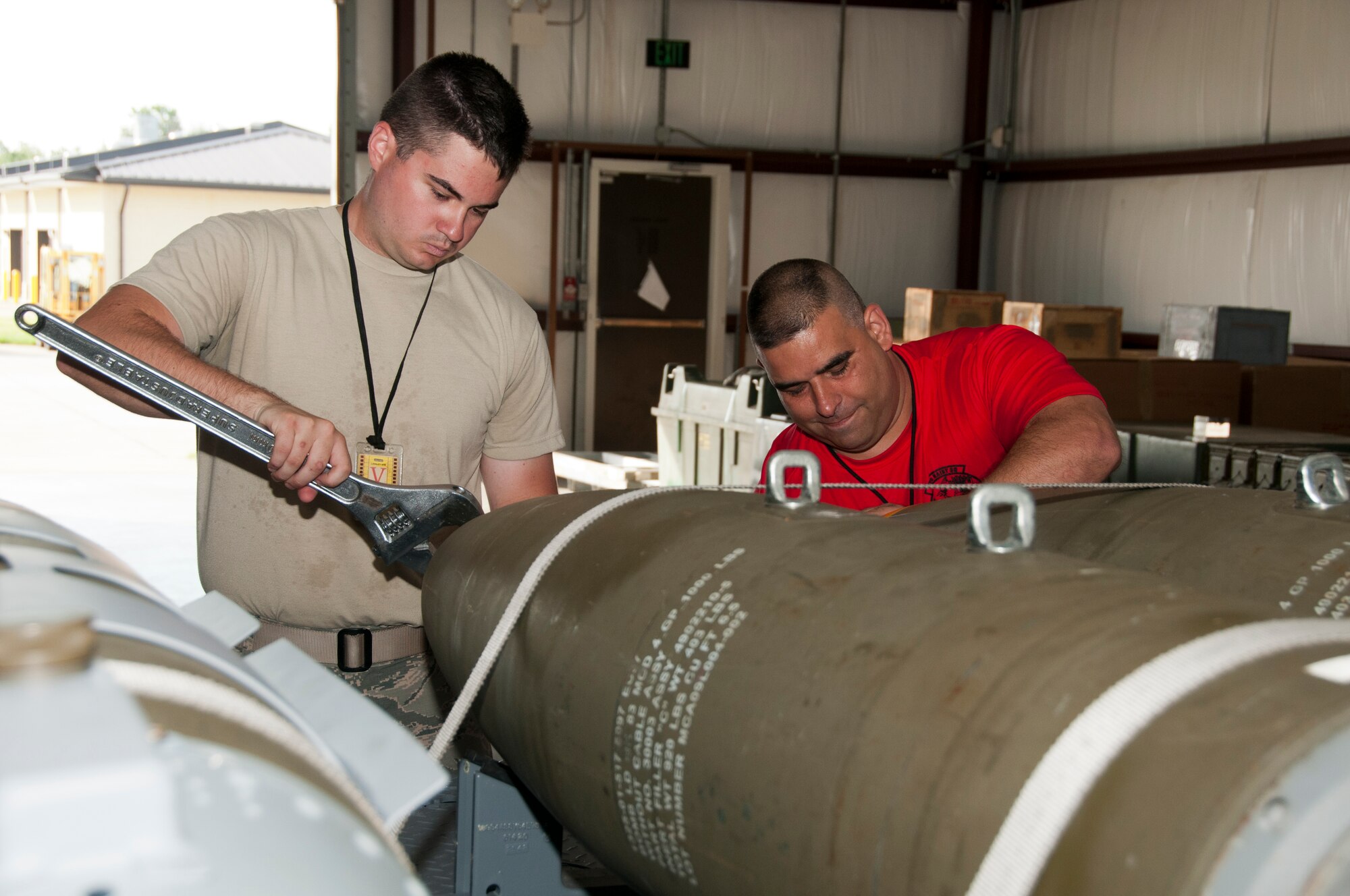 U.S. Air Force Airman 1st Class Randal Trosky, 1st Maintenance Squadron, and Tech. Sgt. Kenneth Stanley, 192nd MXS, ordnance maintenance mechanics, train together while building eight Mark 83 inert bombs for an exercise commemorating Maj. Gen. Billy Mitchell’s bombing of the German battleship Ostfriesland, at Langley Air Force Base, Va., July 10, 2016. Mitchell, often referred to as the ‘Father of the Air Force’, sunk the ship to prove a case for the power of an independent air service.  (U.S. Air National Guard photo by Master Sgt. Carlos J. Claudio)