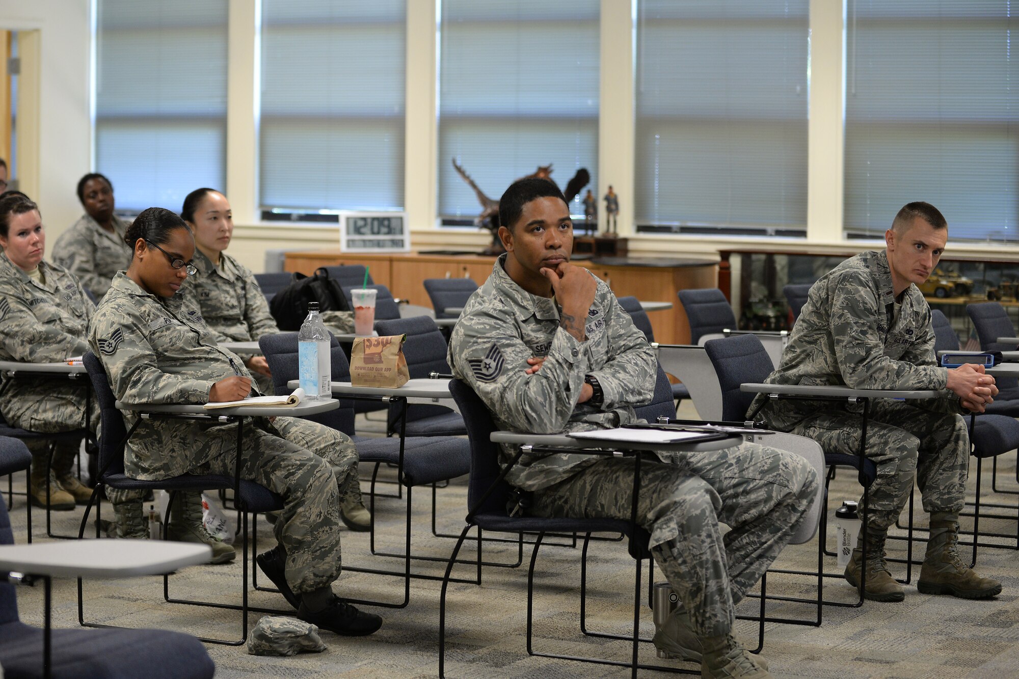 U.S Air Force officers and enlisted members watch an episode of the TV miniseries “Band of Brothers” during a leadership seminar at Langley Air Force Base, Va., July 7, 2016. The miniseries, released in 2001, is based on the non-fiction novel written by historian Stephen E. Ambrose. The series followed the U.S. Army “Easy” Company, 2nd Battalion, part of the 506th Parachute Infantry Regiment, 101st Airborne Division. (U.S. Air Force photo by Staff Sgt. Teresa J. Cleveland)