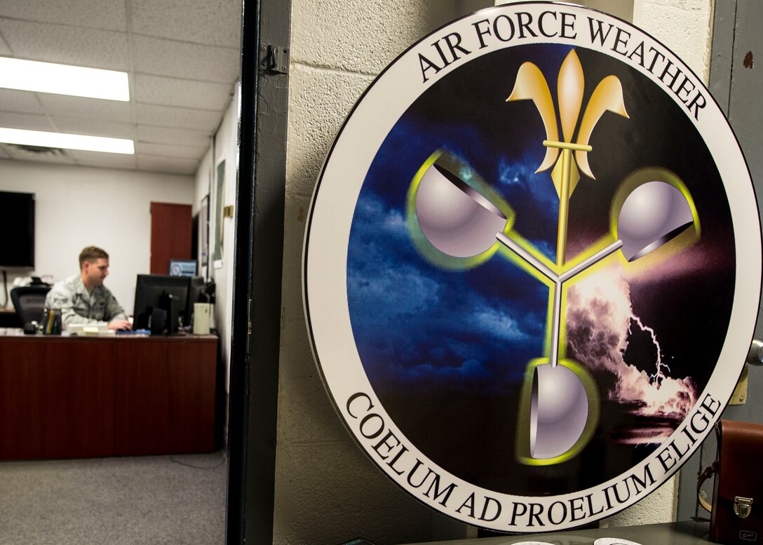 The U.S. Army Air Force Air Weather Service badge is displayed in front of the 1st Operations Support Squadron weather shop at Fort Eustis, Va., June 22, 2016. The badge has a gold fleur-de-lois with the unit's motto ‘COELUM AD PROELIUM ELIGE’ which means,I select the weather for battle. (U.S. Air Force photo by Airman 1st Class Derek Seifert)