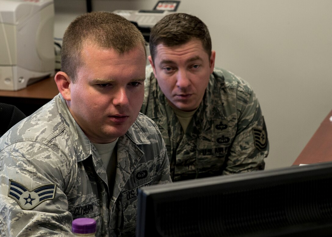 U.S. Air Force Senior Airman Ryan Clyburn, 1st Operations Support Squadron weather forecaster, receives training from Tech. Sgt. Ryan Atkinson, 1st OSS NCO in charge of weather operations of Fort Eustis, at Fort Eustis, Va., June 16, 2016. Training is essential for weather forecasters in order for them to read radars and forecast properly, so the correct information is given to pilots or commanders of the installation. (U.S. Air Force photo by Airman 1st Class Derek Seifert)