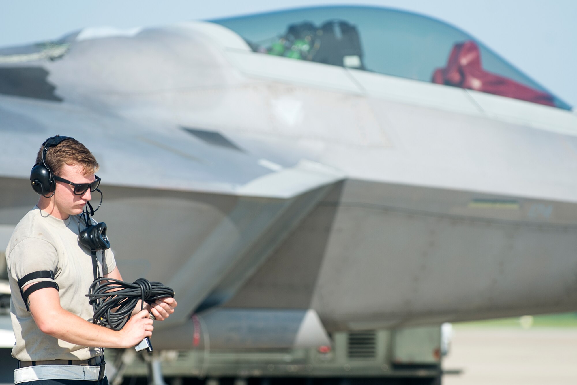 U.S. Air Force Airman 1st Class Steven Prater, 1st Maintenance Squadron weapons load crew member, prepares to launch a F-22 Raptor for Red Flag 16-3 at Langley Air Force Base, Va., July 7, 2016. AF Airmen and service members from allied countries come together during Red Flag at Nellis Air Force Base, Nev., to experience realistic combat scenarios and to train in the event of future conflicts of war. (U.S. Air Force photo by Airman 1st Class Kaylee Dubois)