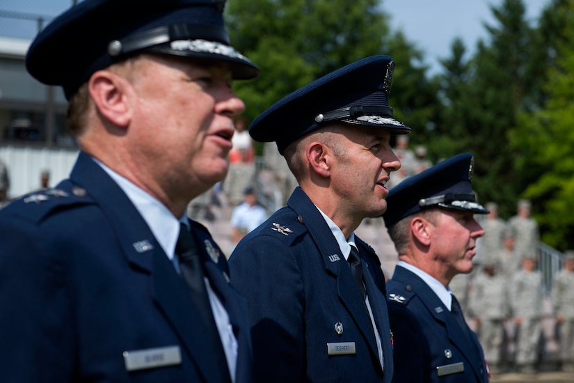 Maj. Gen. Darryl Burke, Air Force District of Washington commander, Col. John Teichert, the new 11th Wing and Joint Base Andrews commander, and Col. Bradley Hoagland, the previous 11th WG and JBA commander, sing the U.S. Air Force Song on the Ceremonial Lawn at Joint Base Anacostia-Bolling, Washington, D.C., July 12, 2016. This ceremony transfers command of the 11th WG and JBA from Hoagland to Teichert. (U.S. Air Force photo by Airman 1st Class Philip Bryant)