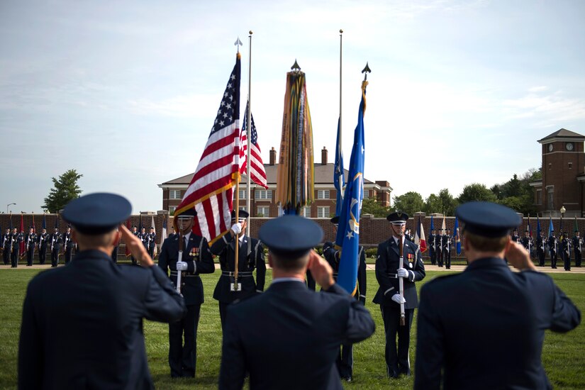 The 11th Wing change of command official party salutes the American flag during the playing of the National Anthem on the Ceremonial Lawn at Joint Base Anacostia-Bolling, Washington, D.C., July 12, 2016. This ceremony transfers command of the 11th WG and Joint Base Andrews from Col. Bradley Hoagland to Col. John Teichert. (U.S. Air Force photo by Airman 1st Class Philip Bryant)