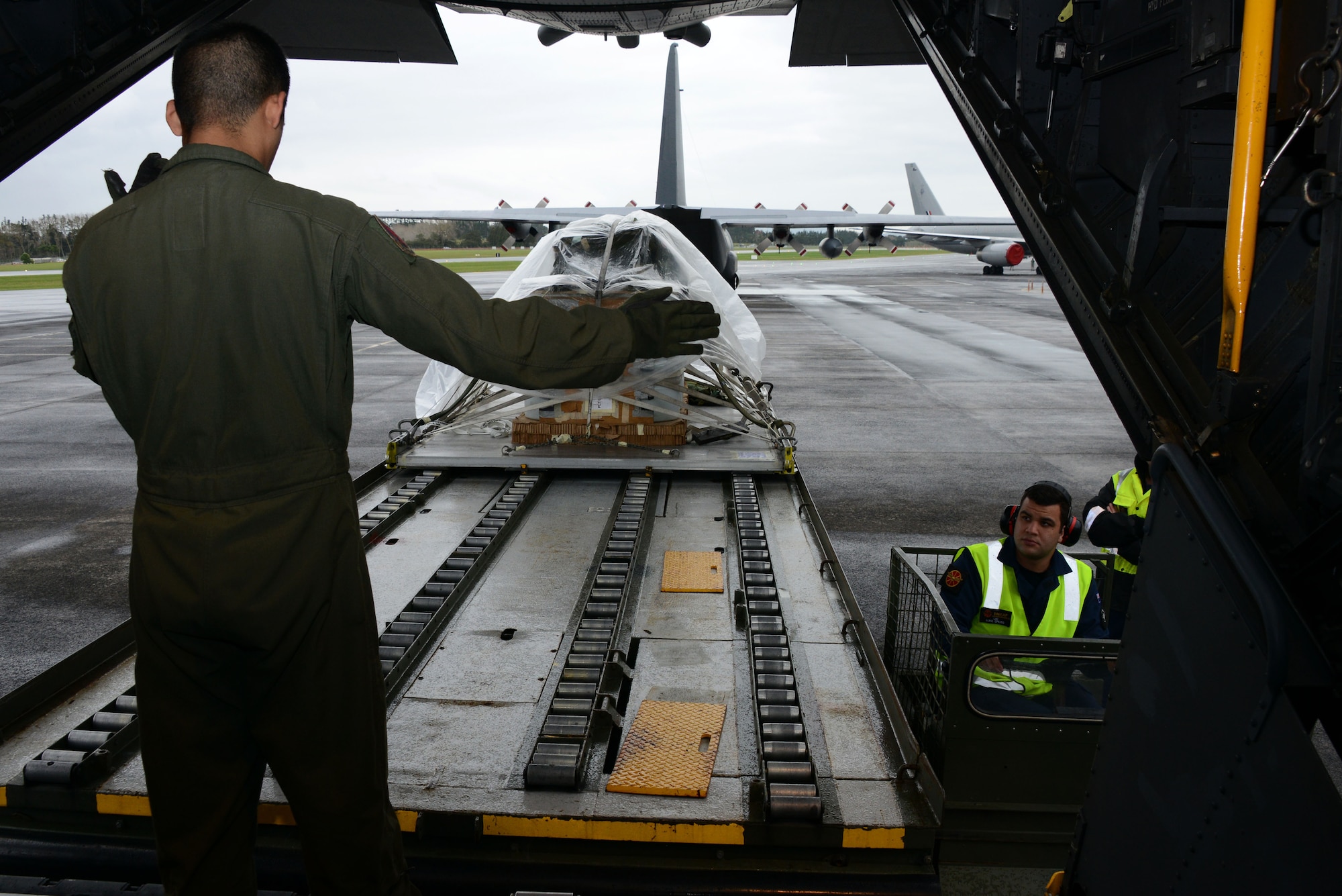 A loadmaster at the 1st Special Operations Squadron, works with a member from the Royal New Zealand Air Force Force to load a heavy equipment platform for an air drop June 20, 2016.  Members from the 353rd Special Operations Group participated in Exercise Teak Net June 12 through June 30 in Whenuapai, New Zealand. During the exercise, members from both the New Zealand Defense Force and U.S. Air Force worked together to conduct personnel and equipment air drops while exchanging new techniques. (U.S. Air Force photo by Master Sgt. Kristine Dreyer)