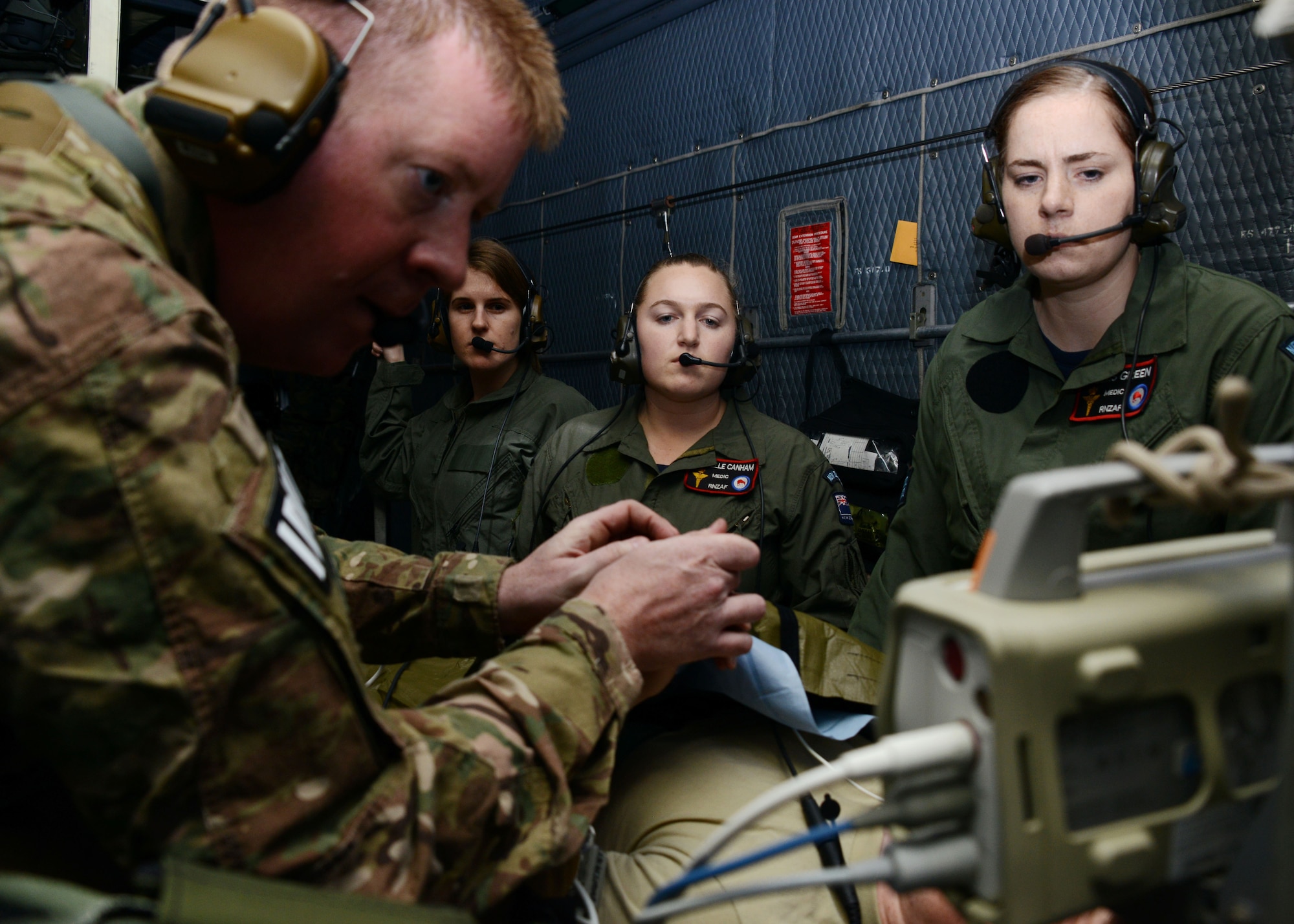 U.S. Air Force Staff Sgt. Jeffrey Tremel, a 353rd Special Operations Support Squadron Independent Duty Medical Technician, goes over patient monitoring and evaluation techniques with Royal New Zealand Air Force medics during casualty evacuation training on board an MC-130H Combat Talon II June 20, 2016.  Members from the 353rd Special Operations Group participated in Exercise Teak Net June 12 through 30 in Whenuapai, New Zealand. (U.S. Air Force photo by Master Sgt. Kristine Dreyer)