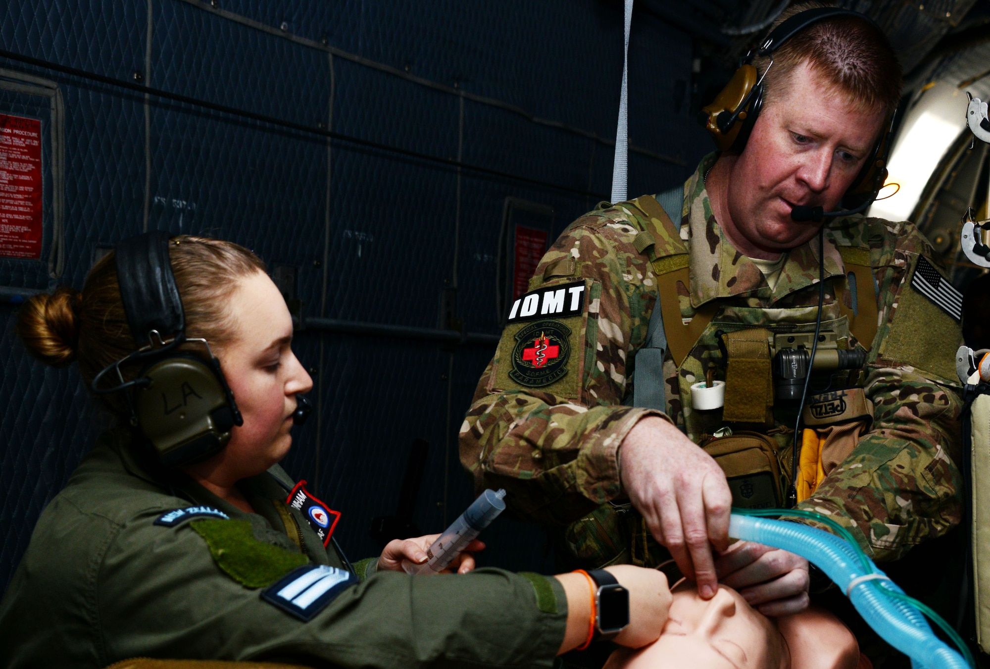 U.S. Air Force Staff Sgt. Jeffrey Tremel, a 353rd Special Operations Support Squadron Independent Duty Medical Technician, conducts advanced airway management techniques with a Royal New Zealand Air Force medic during casualty evacuation training on board an MC-130H Combat Talon II June 20, 2016.  Members from the 353rd Special Operations Group participated in Exercise Teak Net June 12 through 30 in Whenuapai, New Zealand. (U.S. Air Force photo by Master Sgt. Kristine Dreyer)