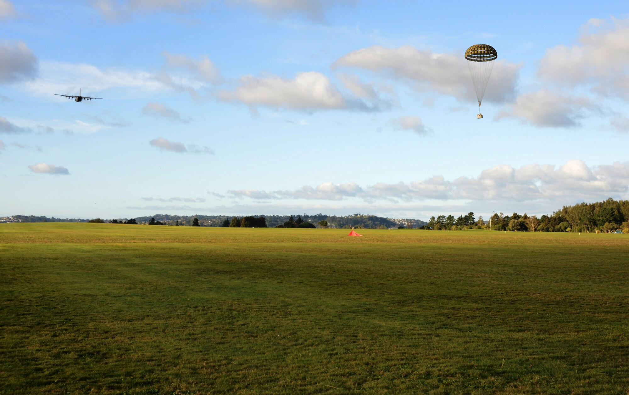 An aircrew from the 1st Special Operations Squadron conducts an airdrop June 19, 2016 from an MC-130H Combat Talon II over a drop zone in New Zealand during Exercise Teak Net. Members from the 353rd Special Operations Group and the New Zealand Defense Forces worked together to build, rig and inspect cargo for air drop during the Exercise Balance Net June 12-30. (U.S. Air Force photo by Master Sgt. Kristine Dreyer)
 
