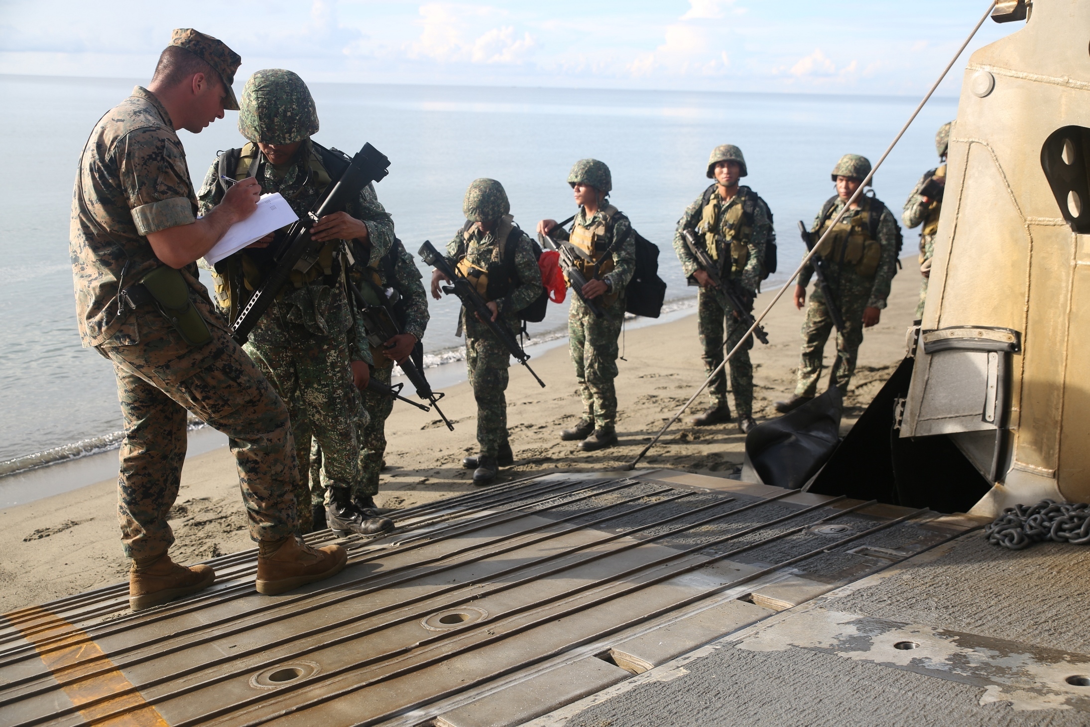 SULU SEA (June 5, 2016) – U.S. Marine Corps Sgt. Alan Cook checks the names of service members of the Philippine Marine Corps as they enter a Landing Craft Air Cushion Hoovercraft to board the forward-deployed Whidbey Island Class dock landing ship USS Ashland (LSD 48).The service members are scheduled to participate in a number of classes and exercies with the Marines and Sailors aboard the Ashland in support of exercise Cooperation Afloat Readiness and Training. CARAT is a series of annual, bilateral maritime exercises between the U.S. Navy, U.S. Marine Corps and the armed forces of nine partner nations to include Bangladesh, Brunei, Cambodia, Indonesia, Malaysia, Singapore, the Philippines, Thailand and Timor-Leste. The Ashland is assigned to the U.S. 7th Fleet.(U.S. Navy photo by Lance Cpl. Carl King Jr/. Released)
