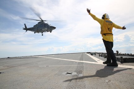 SULU SEA (June 5, 2016) – Boatswains Mate 2nd class Lonnie Sylvester,a sailor aboard the forward-deployed Whidbey Island Class dock landing ship USS Ashland (LSD 48), guides a Philippine helicopter while conducting deck landing qualifications in support of exercise Cooperation Afloat Readiness and Training. CARAT is a series of annual, bilateral maritime exercises between the U.S. Navy, U.S. Marine Corps and the armed forces of nine partner nations to include Bangladesh, Brunei, Cambodia, Indonesia, Malaysia, Singapore, the Philippines, Thailand and Timor-Leste. The Ashland is assigned to the U.S. 7th Fleet.(U.S. Navy photo by Lance Cpl. Carl King Jr/. Released)