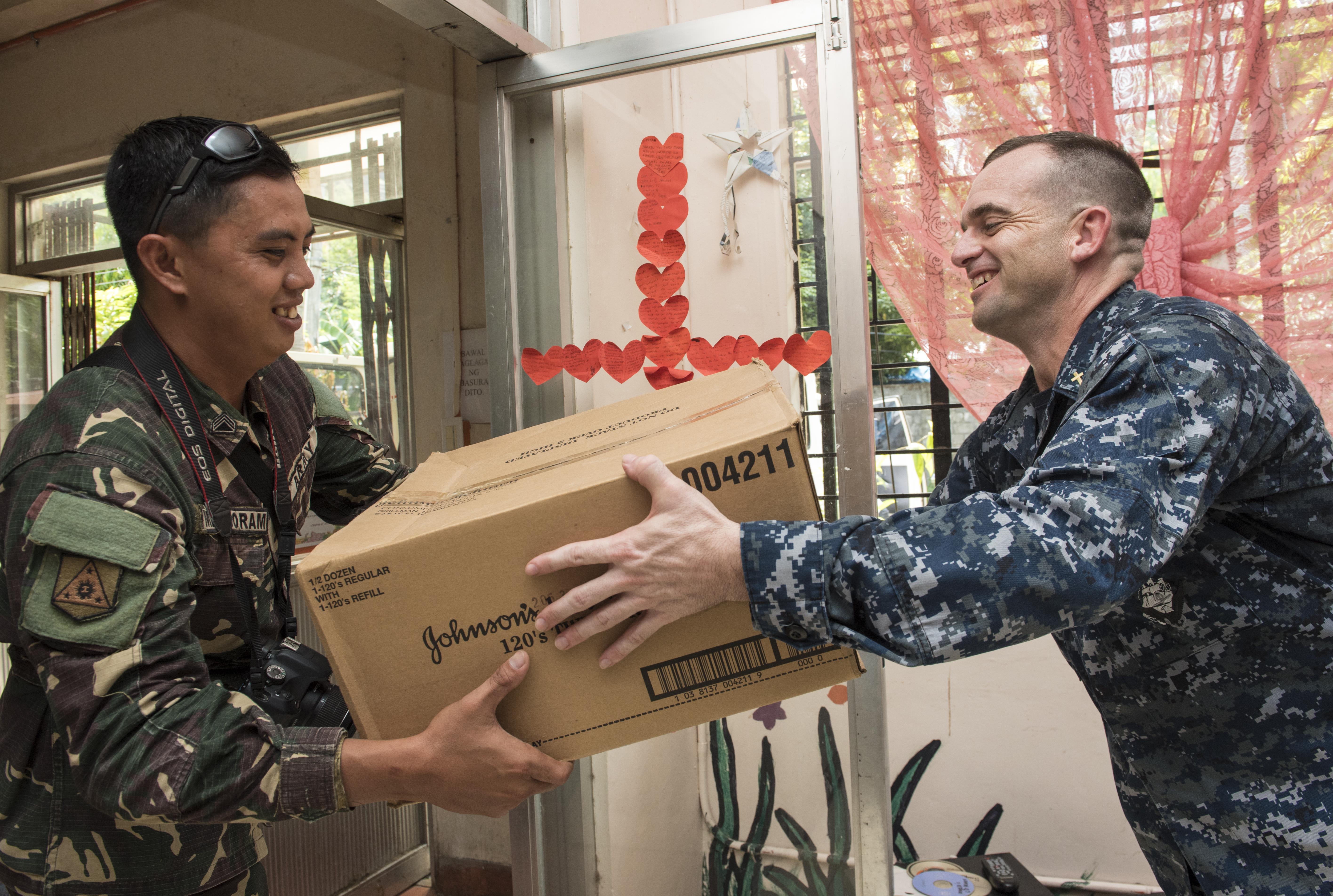 U.S. Navy Chaplain Lt. Russ Ferguson and a Philippine army soldier deliver supplies to residents of the Olongapo Social Development Center while participating in a Project Handclasp outreach program during Cooperation Afloat Readiness and Training (CARAT) Philippines 2016 in Subic Bay, Philippines, June 6, 2016. CARAT is a series of annual maritime exercises between the U.S. Navy, U.S. Marine Corps and the armed forces of nine partner nations to include Bangladesh, Brunei, Cambodia, Indonesia, Malaysia, the Philippines, Singapore, Thailand, and Timor-Leste. (U.S. Navy photo by Mass Communication Specialist 3rd Class Joshua Fulton)