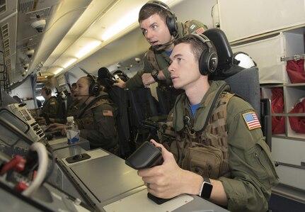 160608-N-OU129-185 SUBIC BAY, Philippines (June 8, 2016) Naval Aircrewman (Operator) 2nd Class Derek Dymer (forward right) and Lt. Matt Hutson (forward left) communicate with Armed Forces of the Philippines aircraft aboard a P-8 Poseidon maritime patrol craft during Cooperation Afloat Readiness and Training (CARAT) Philippines 2016.  CARAT is a series of annual maritime exercises between the U.S. Navy, U.S. Marine Corps and the armed forces of nine partner nations to include Bangladesh, Brunei, Cambodia, Indonesia, Malaysia, the Philippines, Singapore, Thailand, and Timor-Leste. (U.S. Navy photo by Mass Communication Specialist 3rd Class Joshua Fulton/Released)