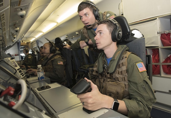 160608-N-OU129-185 SUBIC BAY, Philippines (June 8, 2016) Naval Aircrewman (Operator) 2nd Class Derek Dymer (forward right) and Lt. Matt Hutson (forward left) communicate with Armed Forces of the Philippines aircraft aboard a P-8 Poseidon maritime patrol craft during Cooperation Afloat Readiness and Training (CARAT) Philippines 2016.  CARAT is a series of annual maritime exercises between the U.S. Navy, U.S. Marine Corps and the armed forces of nine partner nations to include Bangladesh, Brunei, Cambodia, Indonesia, Malaysia, the Philippines, Singapore, Thailand, and Timor-Leste. (U.S. Navy photo by Mass Communication Specialist 3rd Class Joshua Fulton/Released)