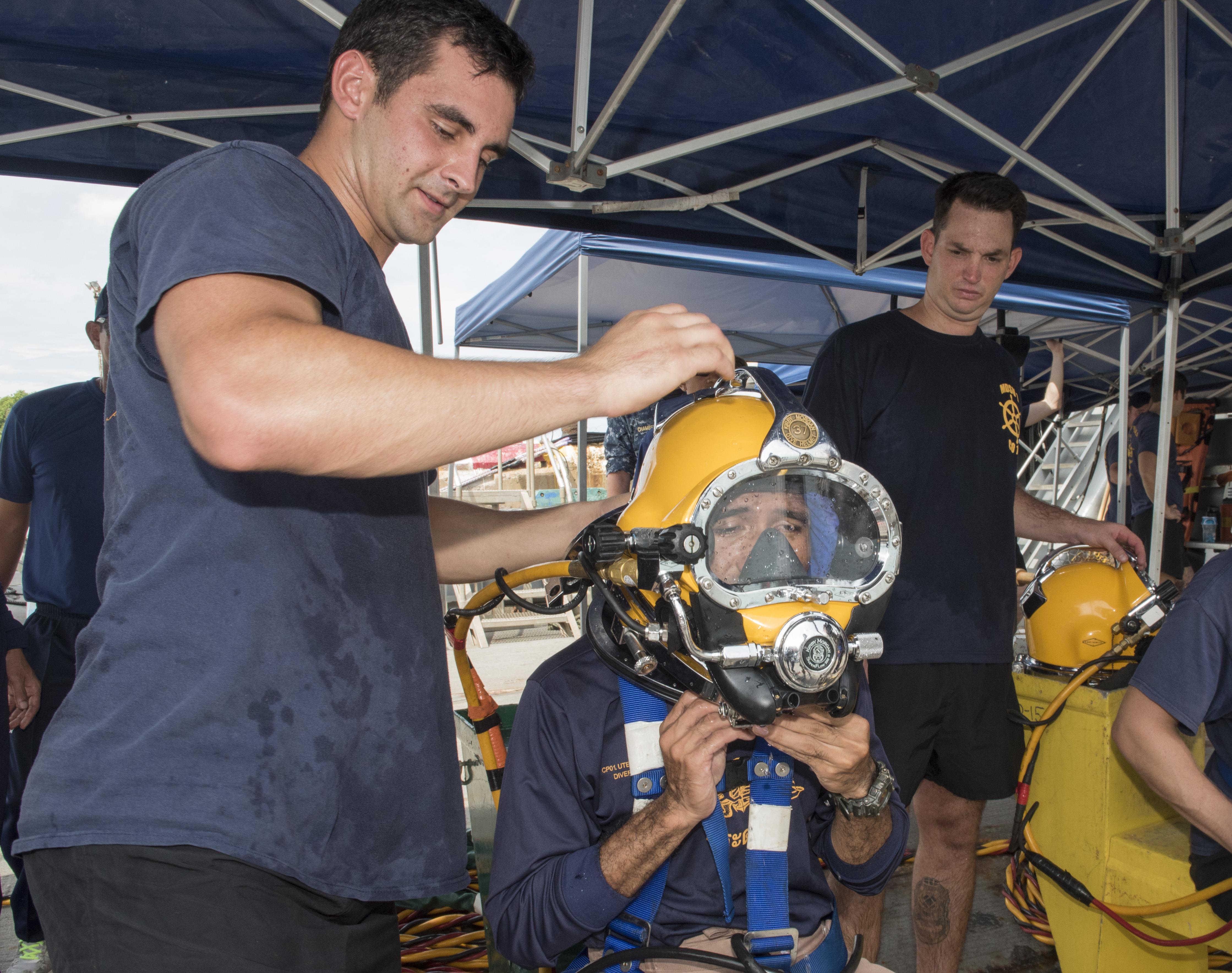 160620-N-OU129-027 SATTAHIP, Thailand (June 20, 2016) Navy Diver 2nd Class Andrew Holden and Navy Diver 2nd Class Lyle Frank from Mobile Diving Salvage Unit (MDSU) 1 makes final preparations on a Royal Thai Navy diver before entering the water during a diving exercise in support of Cooperation Afloat Readiness and Training (CARAT) Thailand 2016. CARAT is a series of annual maritime exercises between the U.S. Navy, U.S. Marine Corps and the armed forces of nine partner nations to include Bangladesh, Brunei, Cambodia, Indonesia, Malaysia, the Philippines, Singapore, Thailand, and Timor-Leste. (U.S. Navy photo by Mass Communication Specialist 2nd Class Joshua Fulton/Released)