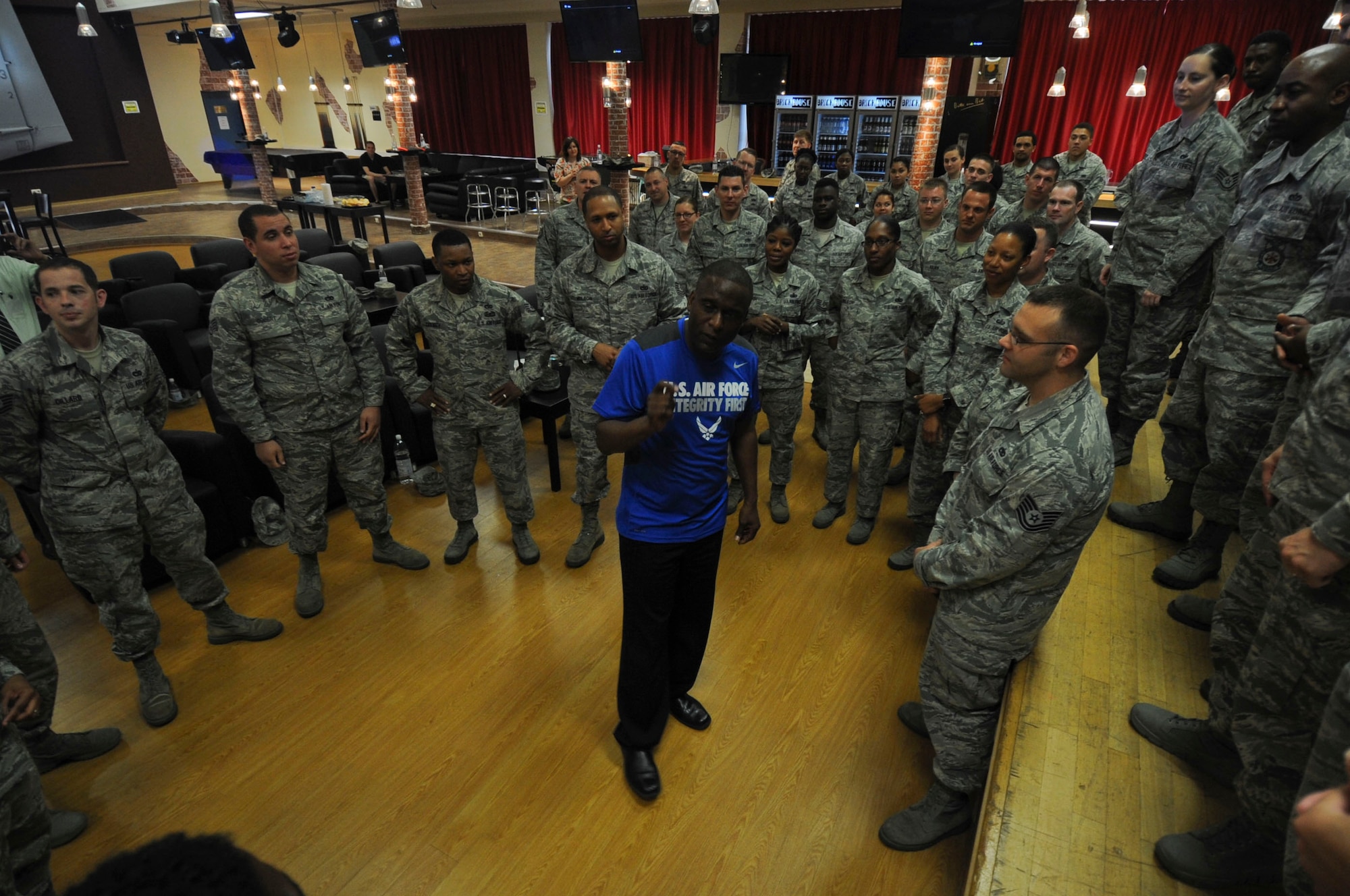 Retired U.S. Air Force Chief Master Sgt. Juan Lewis, known as the Fired Up Chief, speaks to NCOs during a Tier II private organization meeting at the Brick House on Spangdahlem Air Base, Germany, July 12, 2016. Lewis invited the NCOs in the audience to the front of the stage to pose for a group photo at the conclusion of his presentation. (U.S. Air Force Photo by Staff Sgt. Joe W. McFadden/Released)