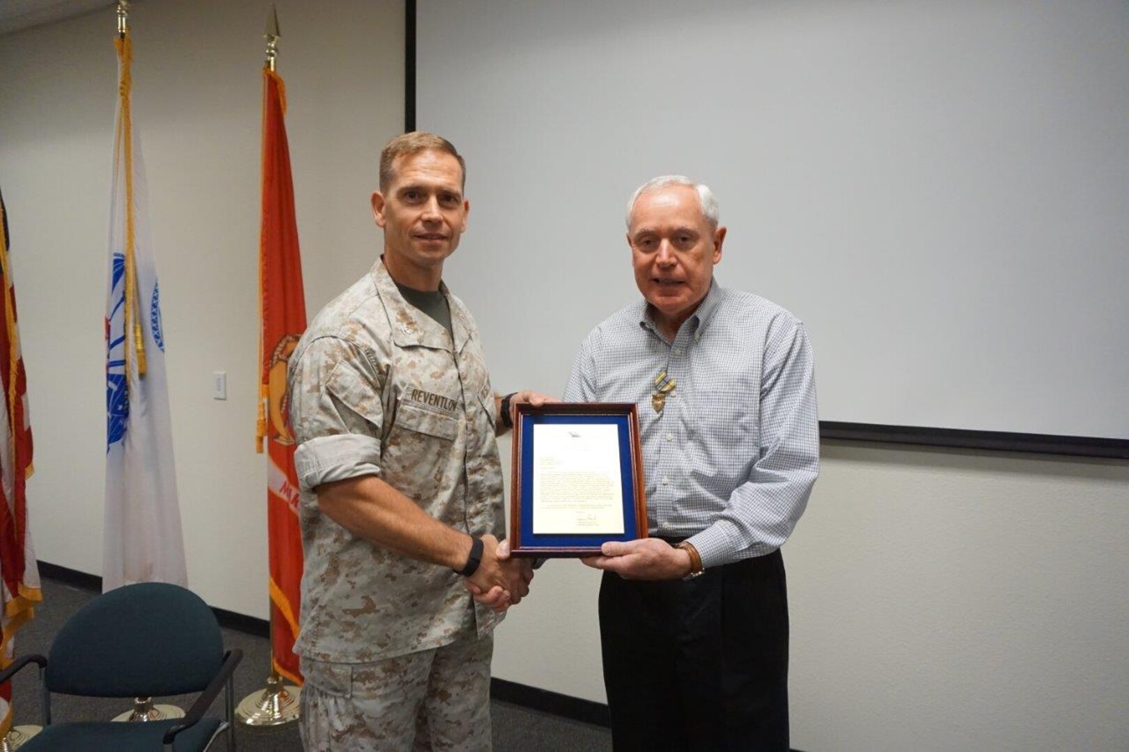 Paul Balash III, right, receives the DLA Exceptional Civilian Service Award from former DLA Distribution San Joaquin, Calif., commander Marine Col. Keith Reventlow prior to retiring.