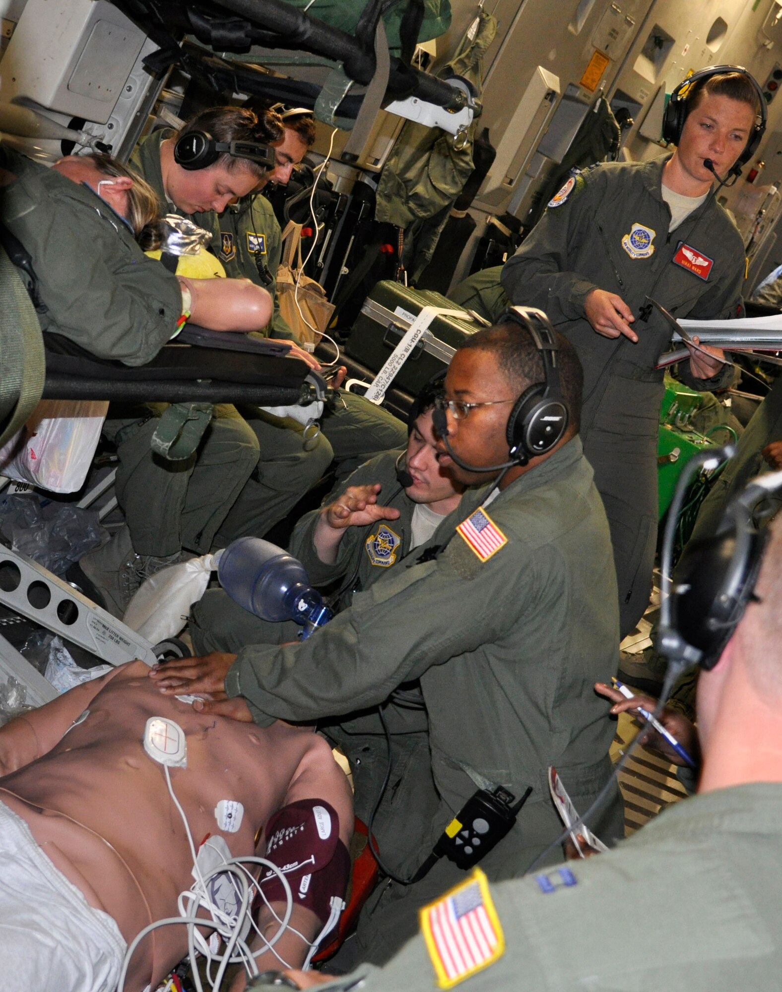U.S. Air Force Airmen from the 514th AES, 375th AES and 43rd AES, practice chest compressions on a dummy, July 10, 2017.  The crew accomplished more than 400 medical training events on the training mission aboard a C17 Globemaster III. (U.S. Air Force photo/Senior Airman Jasmine Zielomski)