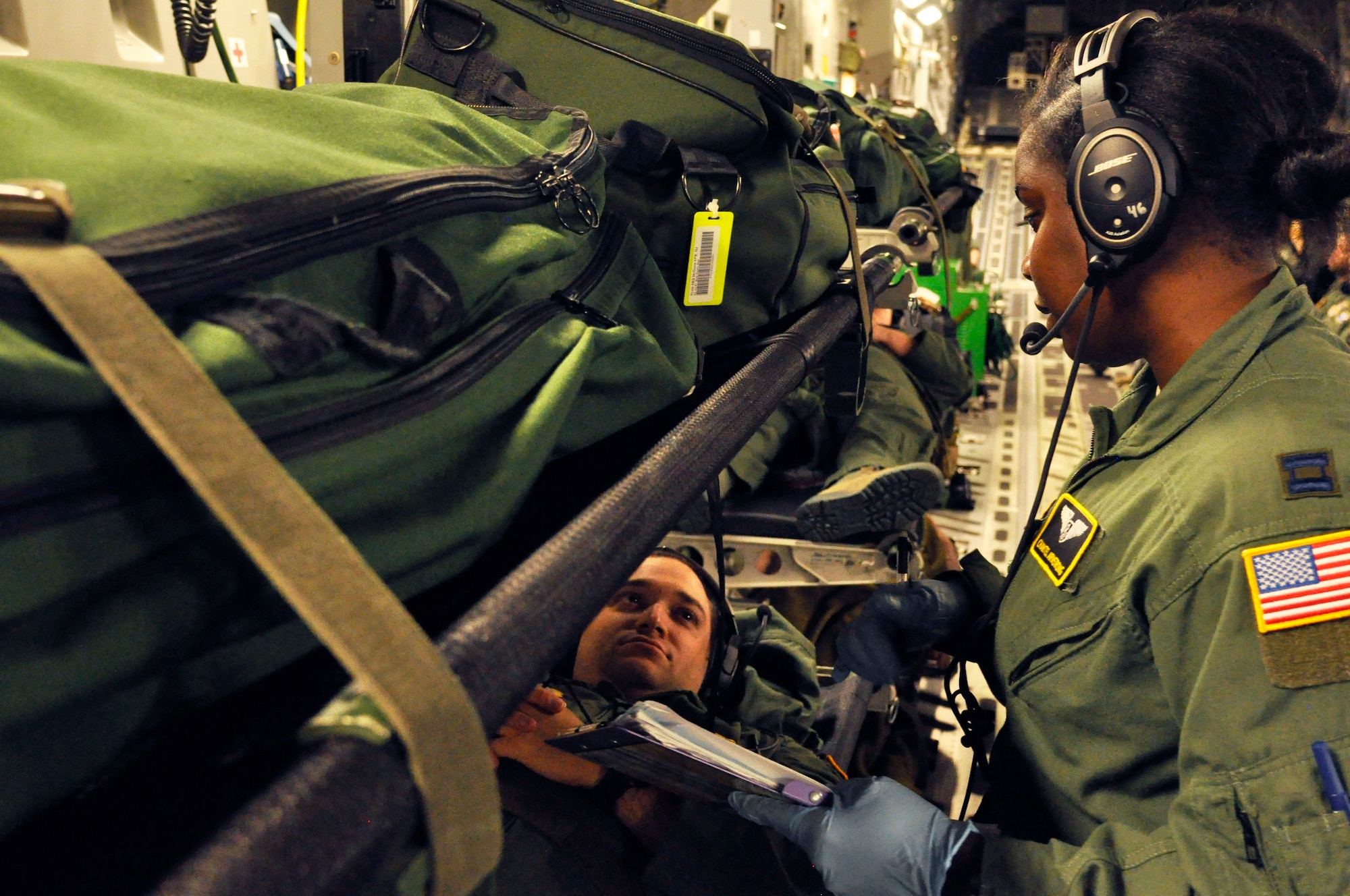 U.S. Air Force Capt. Chantel Armstrong, right, and Staff Sgt. Shawn Raquet, left, with the 43rd AES, simulate a patient receiving care during a medical emergency, July 10, 2016 The crew accomplished more than 400 medical training events on the training mission aboard a C17 Globemaster III. (U.S. Air Force photo/Senior Airman Jasmine Zielomski) 