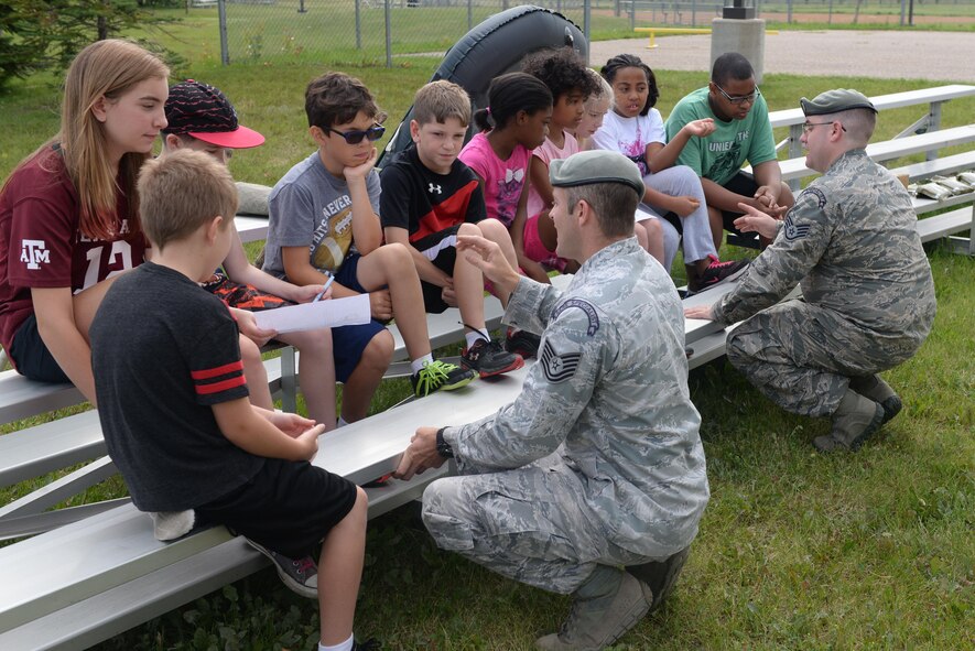 Military Children discuss a list of equipment during a survival exercise during Youth Boot camp at Minot Air Force Base, N.D., July 7, 2016. Children were given a list of supplies and then had to prioritize them in order of most important to least important. (U.S. Air Force photo/Airman 1st Class Jessica Weissman)