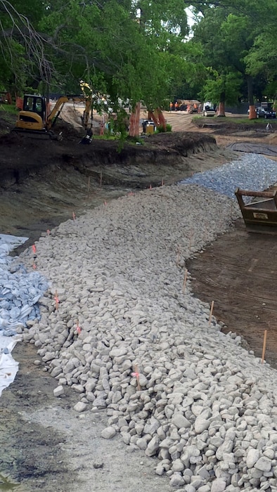 Looking downstream at Upper Fens Pond. Note the construction of the stone protection at the toe of the bank – mid June 2015.