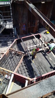 Concrete placement for the right (looking downstream) wing wall pile cap for the new precast concrete Riverway Culvert – early July 2015.