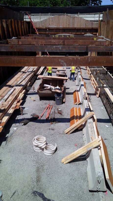 Right (looking downstream) concrete pile cap curing; and reinforcement and formwork being installed at the left pile cap for the new precast concrete Riverway Culvert – mid July 2015.