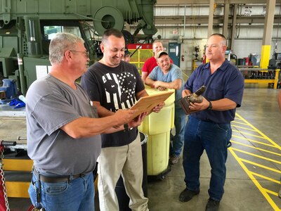 (Front to rear) Michael Hamm (MAST), David Pate, Robert Kilgore, James Butler,
And Samuel Henkel pass around the trophy and plaque presented to them for the Chief of Staff Army Award for Maintenance Excellence. The Area Maintenance Support Activity 147 G in Gray, Tenn., won the US Army Reserve Command-level honors and are competing for the Department of the Army-level award.