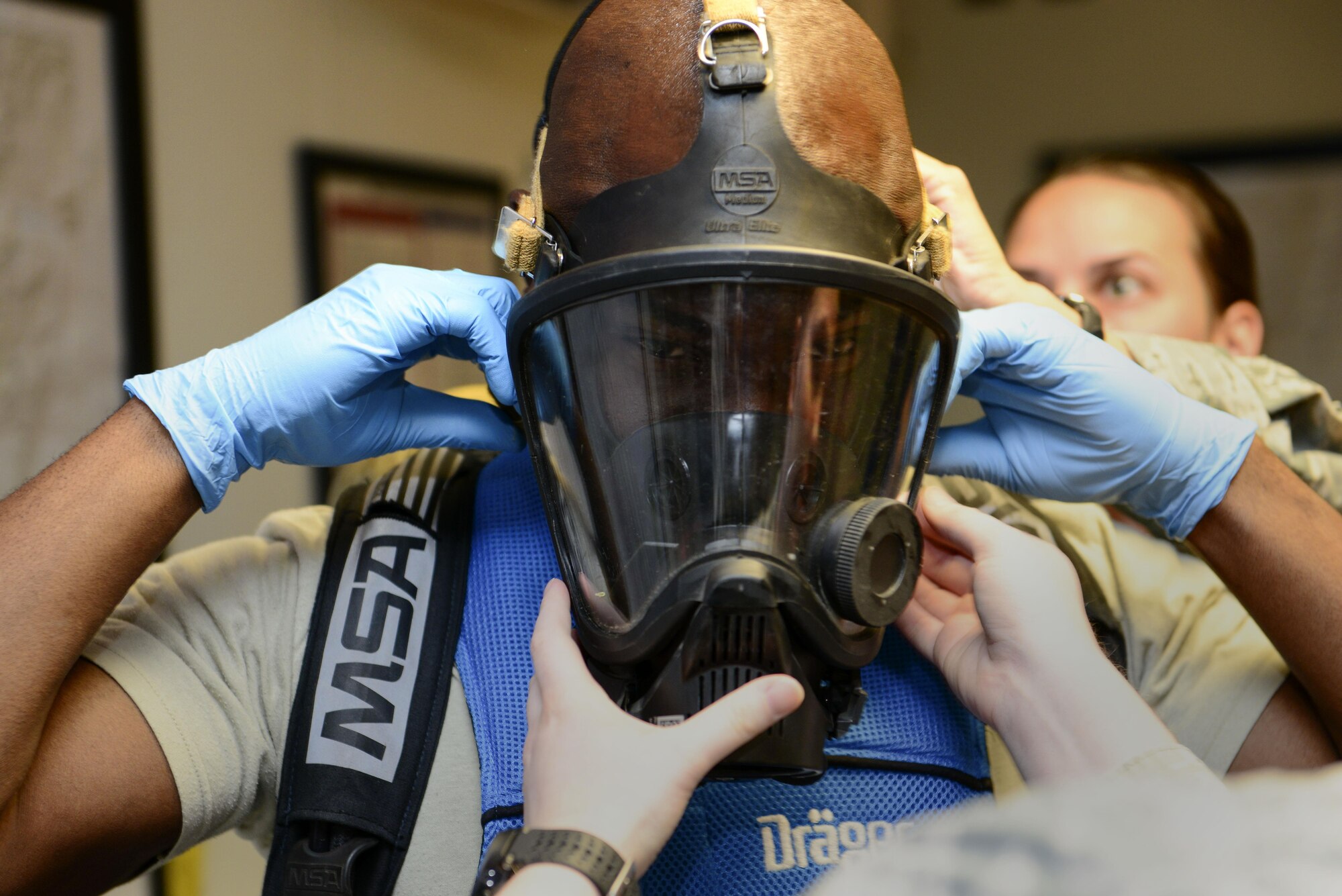 U.S. Air Force Chief Master Sgt. Vegas Clark, 39th Air Base Wing command chief, secures a Level A emergency management suit mask July 13, 2016, at Incirlik Air Base, Turkey. Clark received hands on experience of what the 39th Civil Engineer Squadron readiness and emergency management Airmen bring to the mission. (U.S. Air Force photo by Tech. Sgt. Caleb Pierce)