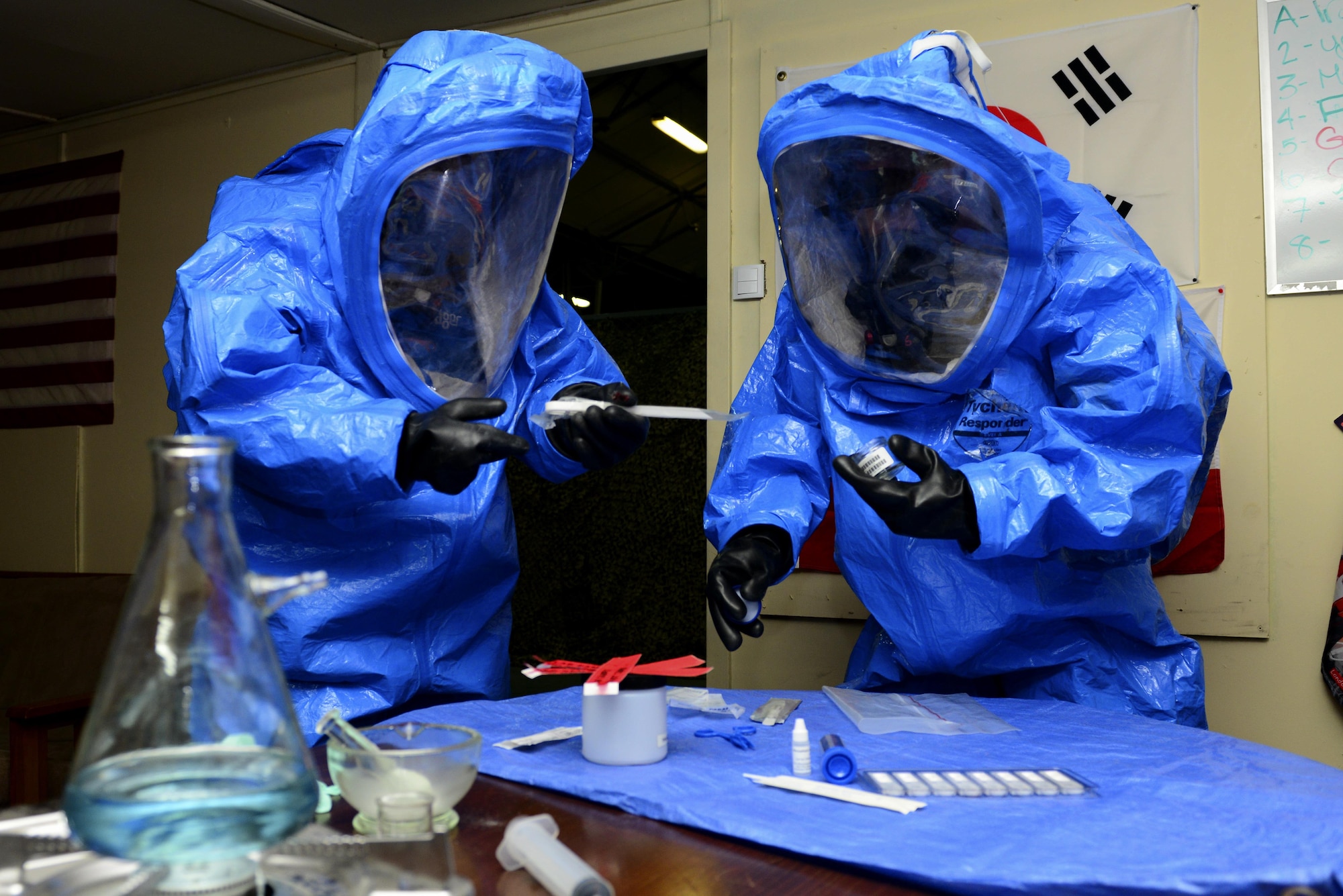 U.S. Air Force Chief Master Sgt. Vegas Clark, 39th Air Base Wing command chief, (left) and Staff Sgt. Joshua Bartley, 39th Civil Engineer Squadron (CES) emergency management journeyman, perform sampling and evidence collection procedures July 13, 2016, at Incirlik Air Base, Turkey. Clark responded to a simulated crime scene during his visit with the 39th CES readiness and emergency management flight. (U.S. Air Force photo by Tech. Sgt. Caleb Pierce)