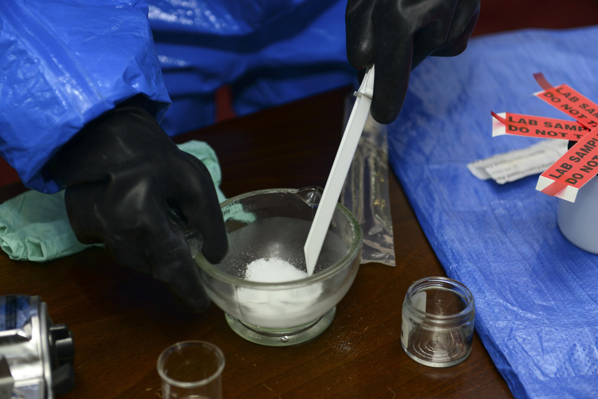 U.S. Air Force Chief Master Sgt. Vegas Clark, 39th Air Base Wing command chief, samples and collects simulated evidence July 13, 2016, at Incirlik Air Base, Turkey. Evidence collection and sampling is one of the many duties performed by the 39th Civil Engineer Squadron readiness and emergency management flight. (U.S. Air Force photo by Tech. Sgt. Caleb Pierce)
